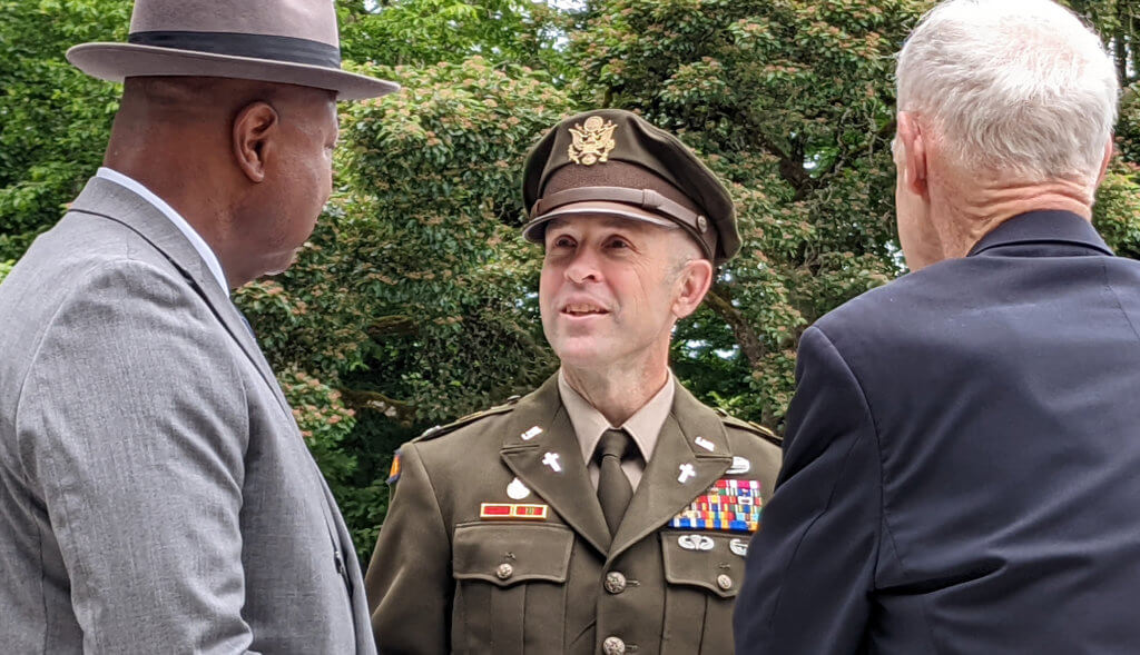 An army officer greets attendees at a public event