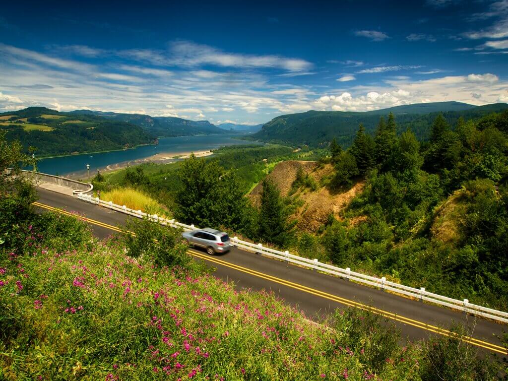 A car drives through scenery on the Columbia River Highway